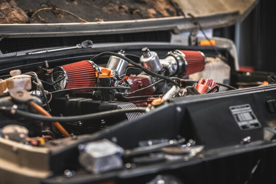 Detailed view of a classic car engine with performance upgrades and new components