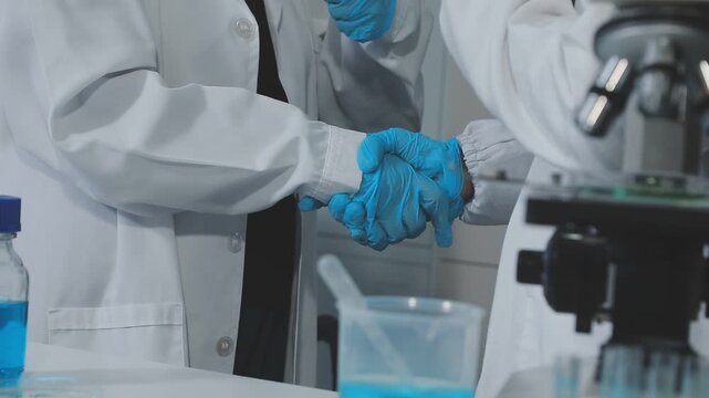 Medical or scientific researcher or man doctor looking at a test tube of clear solution in a laboratory