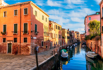 romantic view of a canal in Venice with boats and blue water and beautiful vintage buildings around the cityscape © Yaroslav