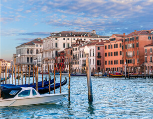 Obraz premium romantic view of a canal in Venice with boats and blue water and beautiful vintage buildings around the cityscape
