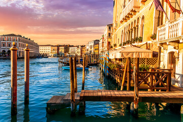 romantic view of a canal in Venice with boats and blue water and beautiful vintage buildings around the cityscape © Yaroslav