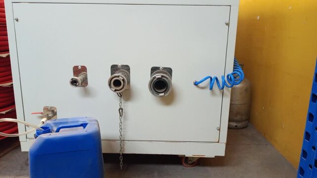 Macro shot of industrial fire equipment connectors including foam outlets and various sized couplings for high-pressure rubber and canvas hose testing.
