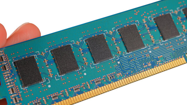 DDR RAM memory chips module macro view. Hand holding Random Access Memory RAM module disconnected from computer motherboard. Manufacturers redirect capacity production for AI data centers processing. 