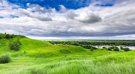 Fototapeta premium Vibrant green hills stretch across the landscape