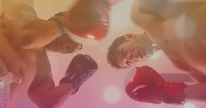 Tapping shirtless boxers leaning over floor camera at gym, with red-blue gloves preparing to spar