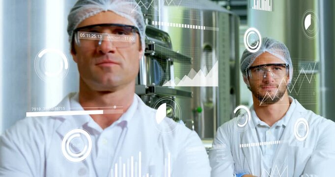 Two techs standing in food plant while camera tightening, data overlays over tanks tracking quality