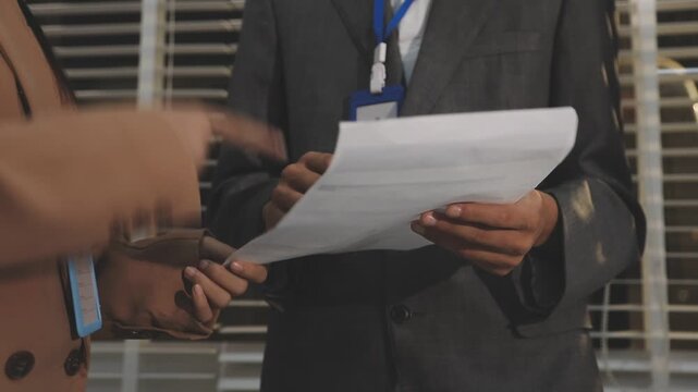 Close up of businessman or accountant hand holding pen working on calculator to calculate business data, accountancy document and laptop computer at office, business concept