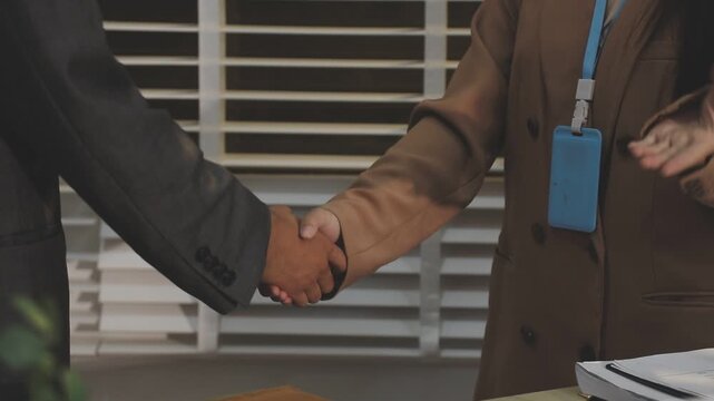 Close up of businessman or accountant hand holding pen working on calculator to calculate business data, accountancy document and laptop computer at office, business concept