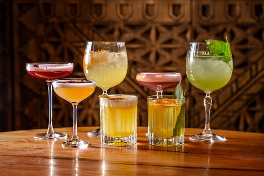 Assorted colorful cocktails in elegant glasses on table