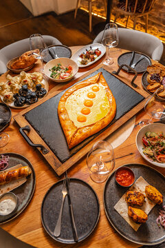 Georgian khachapuri with egg on served table