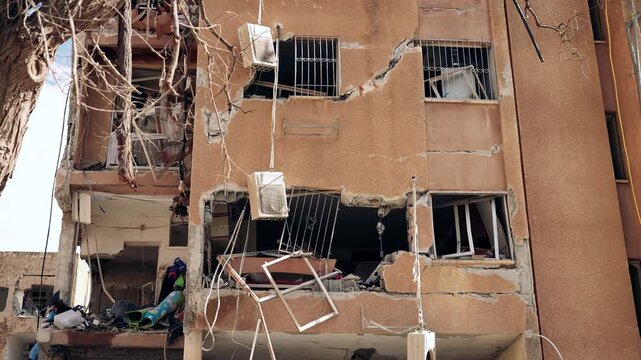 A heavy missile falling site, during the Israel Iran war, where the rocket broke several buildings, killing and wounding civilians. few air condition units are hanging by their tubes. Arad, Israel.
