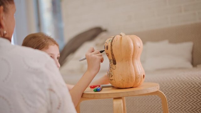 Young girl focused painting pumpkin face, small wooden stool, neat marker palette, subtle living room background, patient supervision from adult, steady hand detailing seeds and ridges, quiet autumn