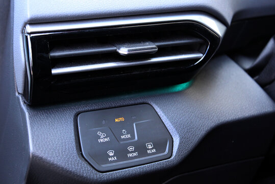 Close-up of black matte plastic headlight control panel in premium electric car. Dashboard for switching on the headlights and fog lights. Fog light symbols, MAX front defroster icon, mode button with