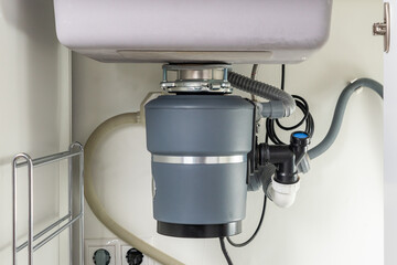 Garbage Disposal under the modern sink, waste chopper concept © Maria
