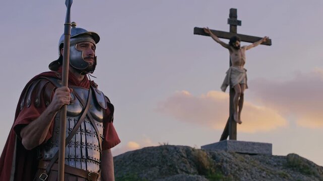 Roman soldier holding spear looking at Christ on cross. Biblical scene for Good Friday and Easter. Religious history.