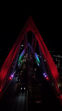 Night drone hyperlapse of Matute Remus bridge in Guadalajara Mexico with traffic and LED lights.