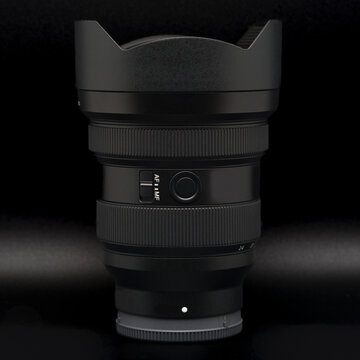 A 12-24 mm ultra wide-angle zoom lens on a black background