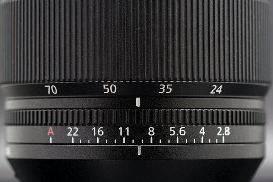 Close up of the aperture and zoom rings of a full-frame 24-70 mm digital camera zoom lens.
