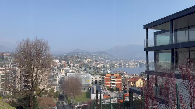 Panoramic view of Lugano city and Lake Lugano from Monte San Salvatore funicular railway, Switzerland, urban and mountain landscape
