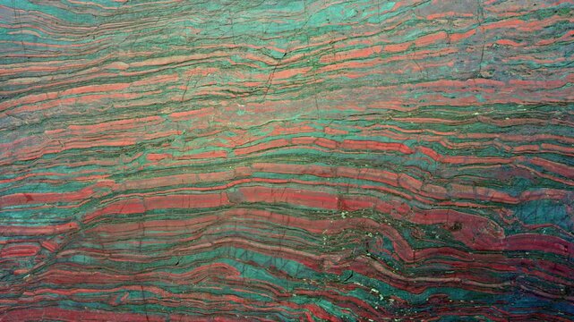  Close up cut red stone with natural patterns and texture. Banded iron ore. Mineral structure, geological layers, natural background for design.
