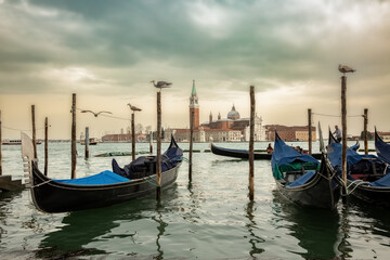 Naklejka premium Gondolas moored in Venice with San Giorgio Maggiore church in the background