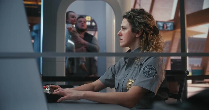 Professional Adult Woman in Airport Security Uniform Works at Surveillance Station, Ensuring Passenger Safety. Concept of Reliable Transport Security, Border Protection, and Professional Duty.