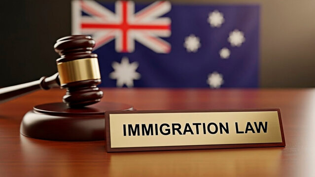A gavel and sign reading Immigration Law on a desk with the Australian flag in the background.
