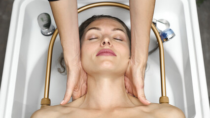 Close up of relaxing facial massage therapy performed by professional in spa.
