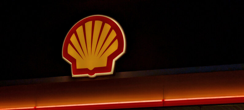 Leicester, England, UK - 6 February 2026: Illuminated Shell logo at night, yellow and red pecten shell signage on dark background, night-time gas station branding