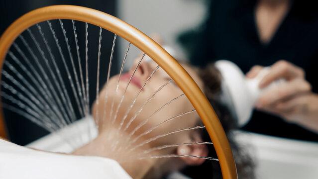High-end Japanese head spa session with massage device for deep wellness and relaxation.
