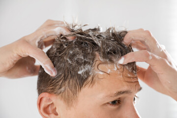 Fototapeta premium Man washing his hair with shampoo in bathroom, closeup