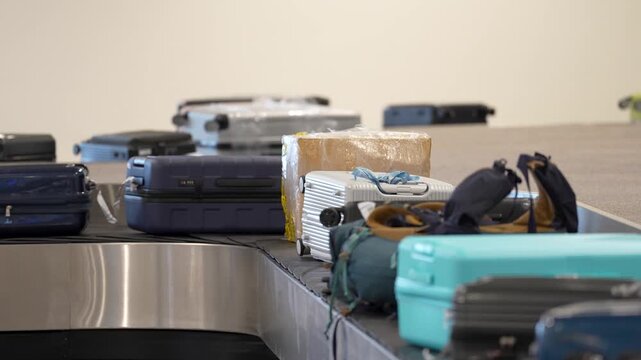 Luggage safety and transportations system, conveyor belt filled with bags and suitcases with flight passes moving on automatic belt line in arrival area, baggage transporting inside airport terminal.