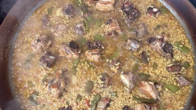 Traditional spanish valencian paella cooking in a pan