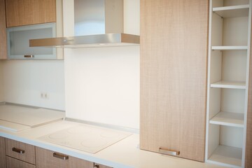 Fototapeta premium Modern kitchen interior with wooden cabinets and stainless steel appliances
