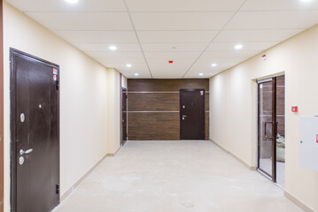 Fototapeta premium Modern hallway with doors and lighting in contemporary building interior