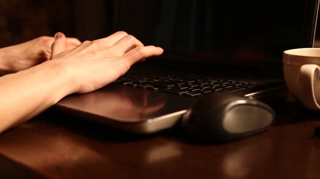 Business woman typing on keyboard the fingers, drinking coffee. Laptop placed on the wooden desk near coffee cup and computer wireless mouse. Closeup series of videos from different angles