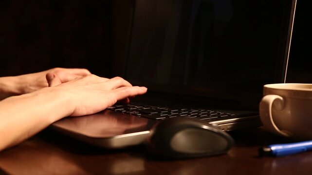 Business woman typing on keyboard the fingers, drinking coffee. Laptop placed on the wooden desk near coffee cup and computer wireless mouse. Closeup series of videos from different angles