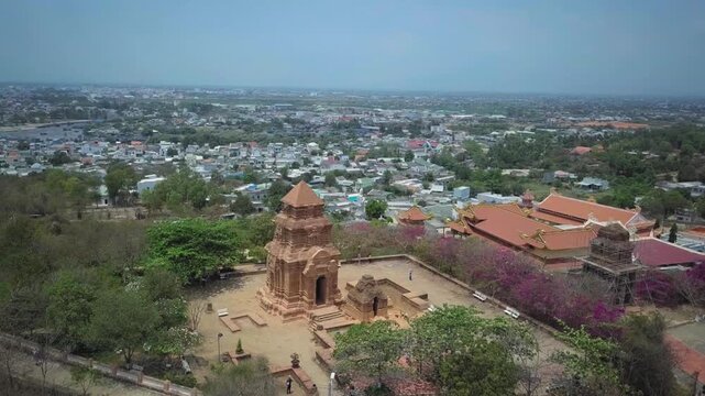 High-angle view showing the ancient poshanu cham tower complex and the cityscape of phan thiet, vietnam