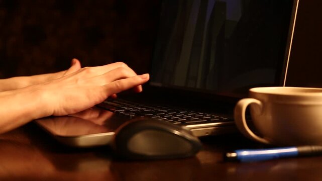 Business woman typing on keyboard the fingers, drinking coffee. Laptop placed on the wooden desk near coffee cup and computer wireless mouse. Closeup series of videos from different angles