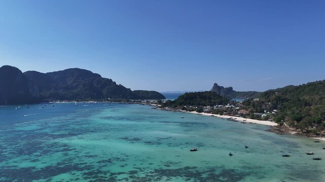 Beautiful aerial view of Phi Phi island with turquoise water beaches and boats creating a perfect tropical scene ideal for travel tourism vacation and luxury resort advertising