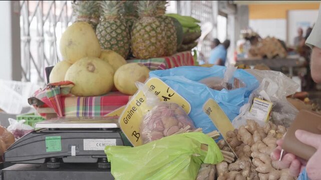Hand-to-Hand Cash Transaction at Local Caribbean Market: Customer Paying for Fresh Tropical Produce and Ginger