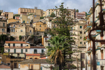 Naklejka premium Beautiful panorama of a Sicilian city, Modica, Italy, ancient architecture on a hill with typical Sicilian buildings, no people, a combination of old and new architecture, houses in the city, panorama
