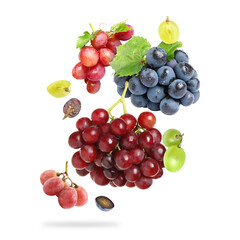 Fototapeta premium Fresh juicy grapes and green leaves falling against white background