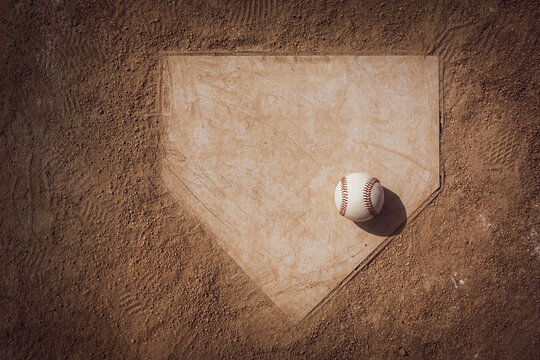Baseball on home plate of sports field