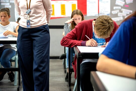 Students focused during classroom exam.