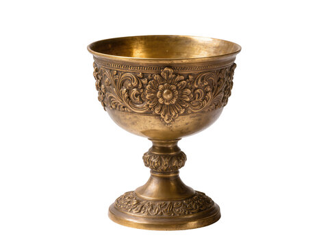Isolated ornate antique golden chalice with intricate floral carvings and metal details