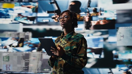 Obraz premium Intelligence agency professional scanning enemy rockets using tablet app. Military operator using radar systems on device to detect incoming ballistic missiles, serving country, camera A