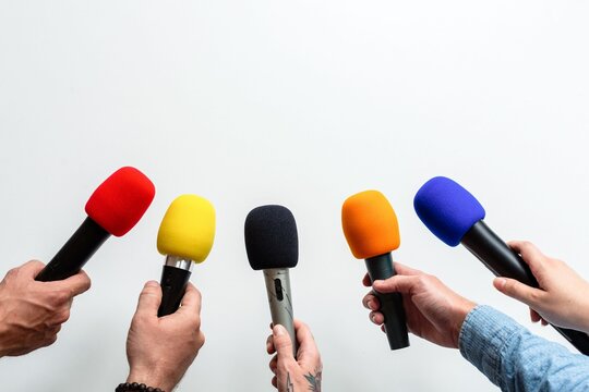 Colorful microphones in hands photo