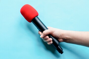 Red microphone held firmly photo