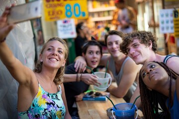 Fototapeta premium Friends enjoying vibrant street selfie.